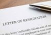 Resignation letter with a pen on top.