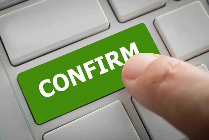 1019508196 featured image Finger pressing green confirm button on keyboard