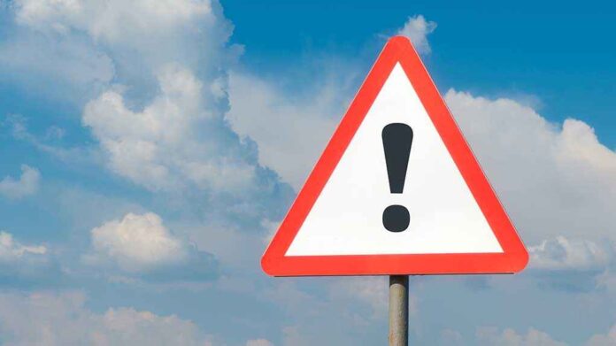 1783780781 featured image Warning sign with exclamation mark against cloudy sky.