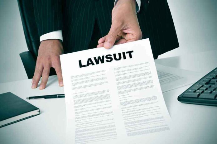 189871757 featured image Person holding a document labeled "Lawsuit."