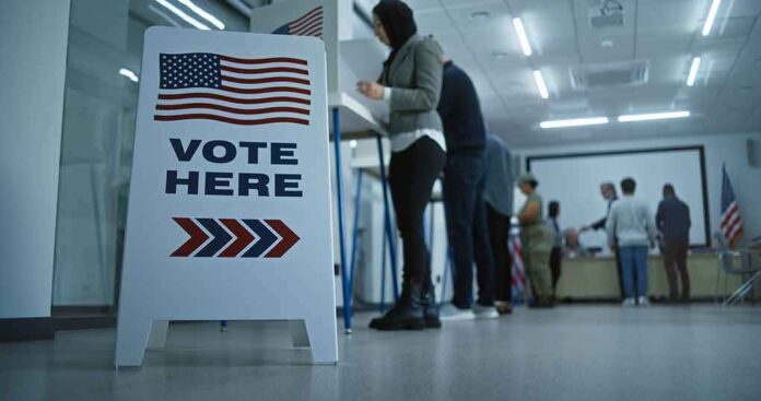 2451104599 featured image Sign reading "Vote Here" in a polling station.