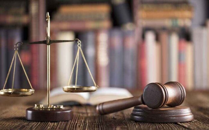 666508099 featured image Gavel and scales on desk with books.