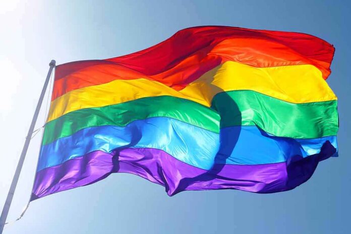 115334458 featured image Rainbow flag waving against clear blue sky
