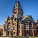 Image shows famous Harvard building against a blue sky.