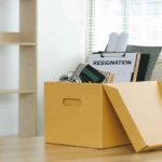 Yellow box with resignation notice on an office desk