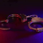 Handcuffs with red and blue dramatic lighting