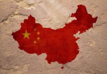 Map of China with flag on textured wall