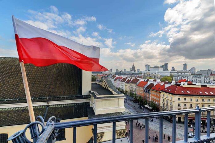 704626399 featured image Polish flag over cityscape with buildings and cloudy sky.