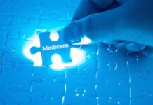 Hand placing Medicare puzzle piece under blue light