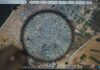 Magnifying glass over map showing Gaza location