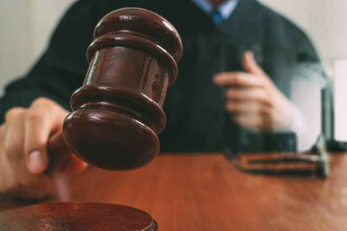572416810 featured image Judge holding gavel over wooden block.