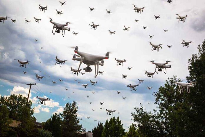 709014991 featured image Many drones flying in a cloudy sky.
