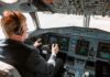 Pilot in cockpit operating airplane controls