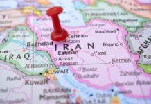 Red pushpin marking Iran on a map