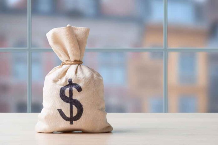2425646037 featured image Money bag with dollar sign on table