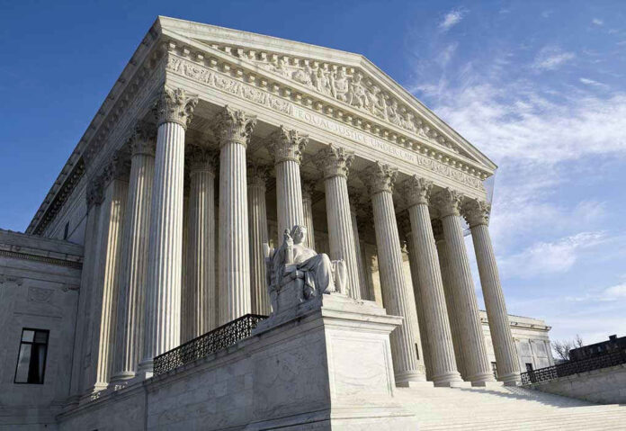 Supreme Court building with columns and statue in front