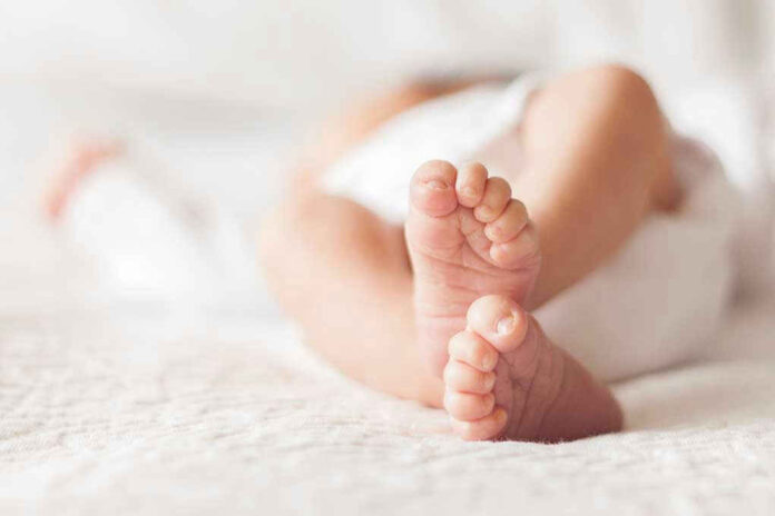 Close-up of baby feet lying on blanket