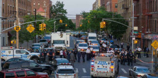 Police activity on a city street with emergency vehicles