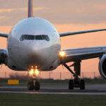 Airplane on runway during sunset