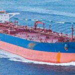 Large cargo ship navigating through the ocean