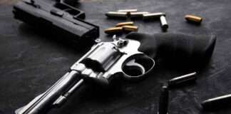 Revolvers and bullets on a dark surface