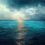 A serene ocean view with a dramatic sky and sunset reflection on the water