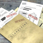 Congress Finally Puts Epstein Victims First Classified documents with Top Secret stamps on wooden surface.