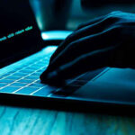 Typing Obsolete? New KEYBOARD TECH Stuns Hand typing on laptop with code on screen.