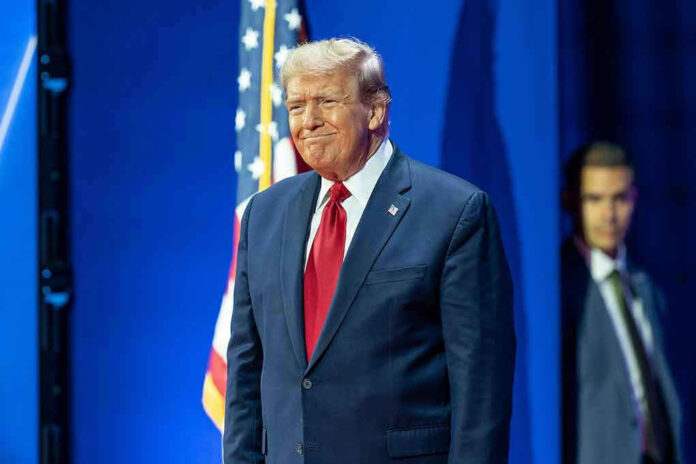 Man in suit next to American flag
