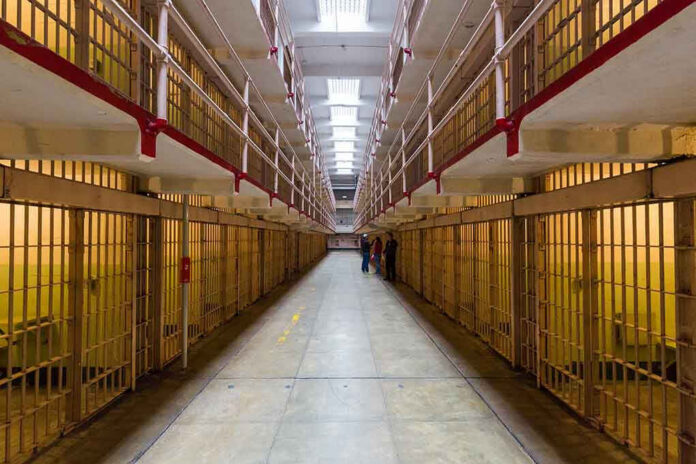 Long hallway with prison cells on both sides