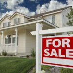 Why Senior Homeowners Are Abandoning Properties En Masse A suburban house with a For Sale sign in the front yard