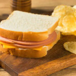 Ham and cheese sandwich with potato chips