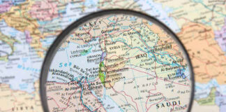 Magnifying glass over Middle East map highlighting Israel and Egypt