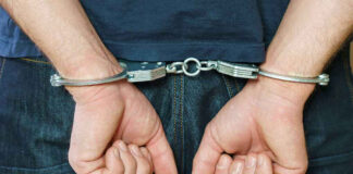 Person in handcuffs behind their back