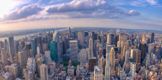 Aerial view of city with skyscrapers and cloudy sky
