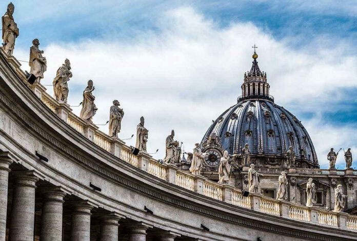 368201633 St Peters Basilica dome with statues and clouds