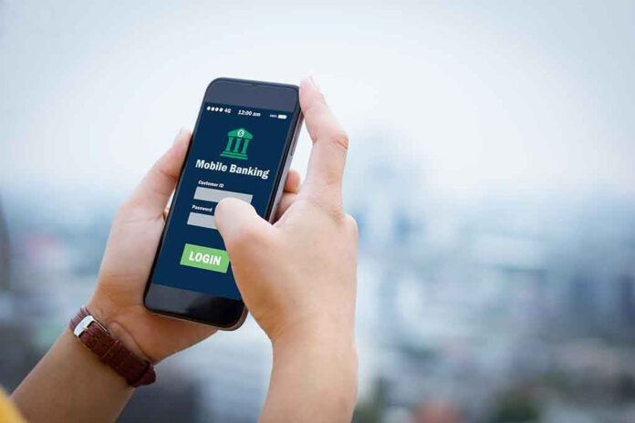 564088018 Person using mobile banking app on smartphone