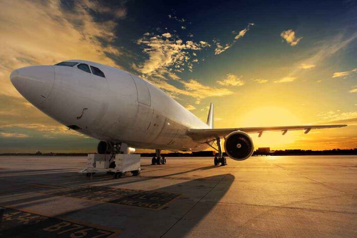 shutterstock_133550825.jpg An airplane parked on the runway during sunset with a colorful sky