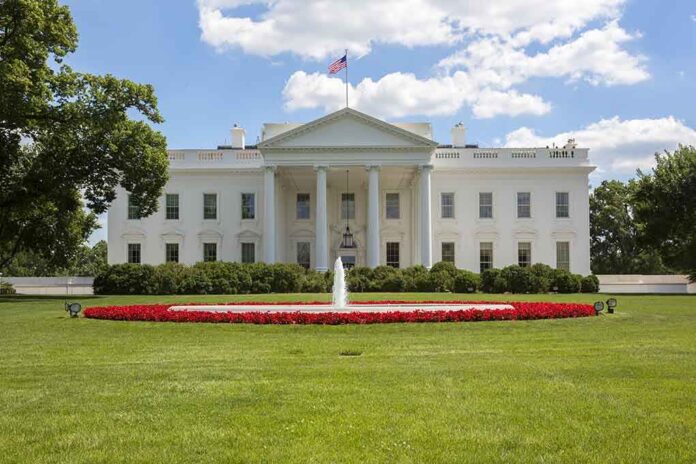 shutterstock_225269257.jpg The White House with a fountain and flower beds in front