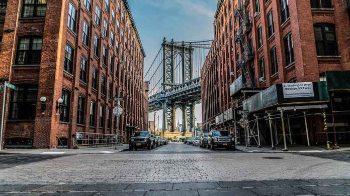 Street view with bridge between two brick buildings
