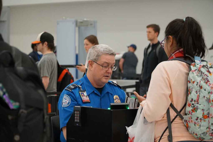 1641623299 TSA agent checks passengers documents at airport security
