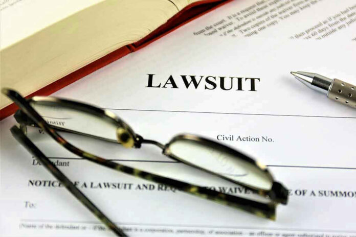 Lawsuit paperwork with glasses, pen, and an open book.