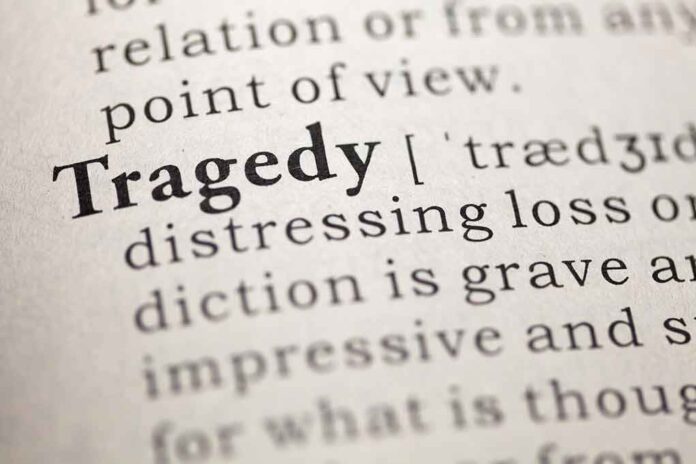 Close-up of a dictionary page showing the definition of 'tragedy'