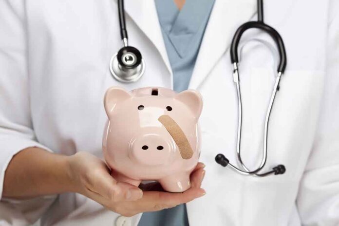 A doctor in a white coat holding a piggy bank with a bandage on it