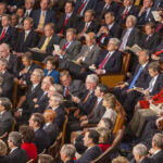 STUNNING Vote Exposes Democrats’ Shocking Stance Audience of officials sitting and reading documents in auditorium.
