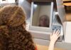 SAVE America Act Sparks Voter Chaos A person using an electronic voting machine at a polling station