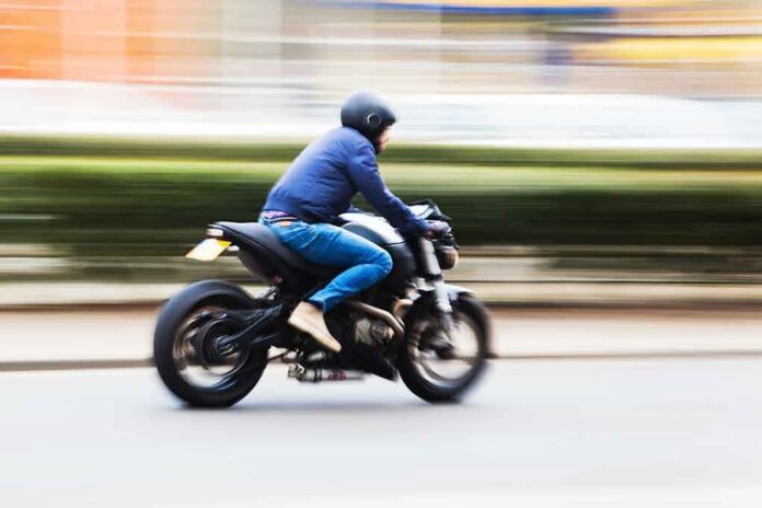 shutterstock_156053021.jpg A person riding a motorcycle swiftly through an urban area