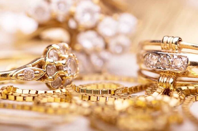 Close-up of various gold rings adorned with sparkling gems