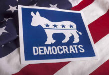Dem Darling DEMOLISHED — Every Ally Vanishes Overnight Democrats logo on American flag background