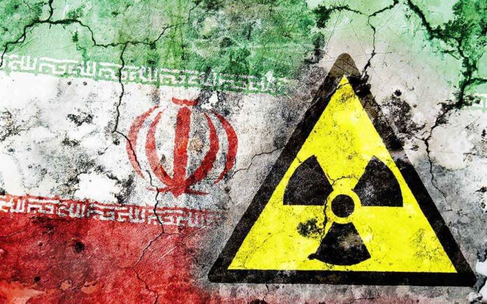 A cracked wall featuring the Iranian flag and a nuclear warning symbol